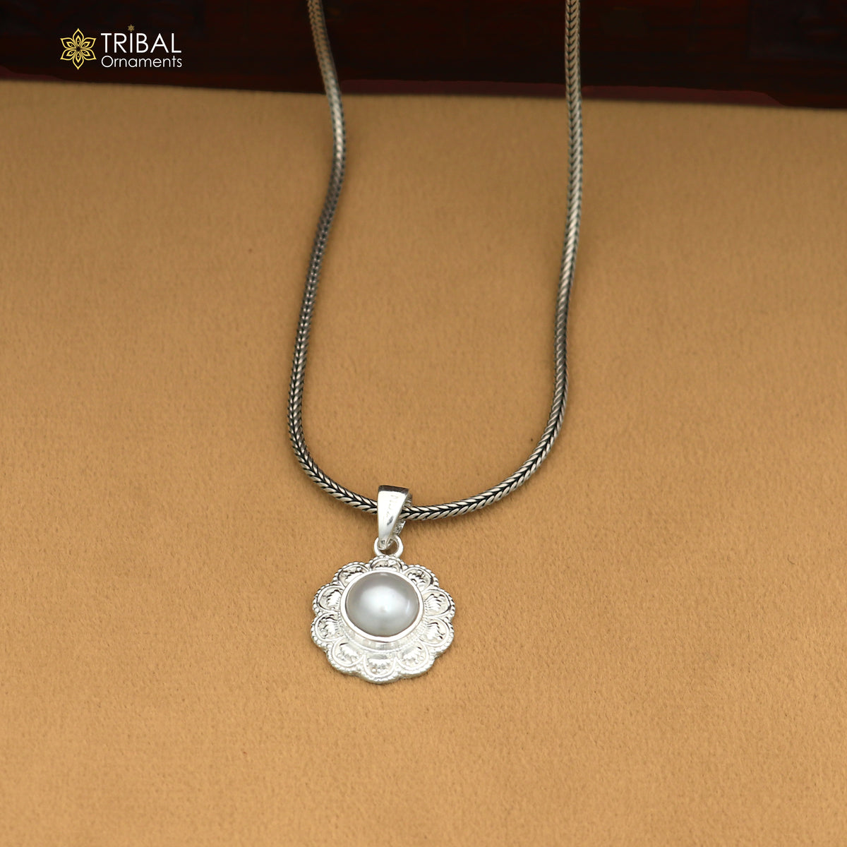 Sterling silver round floral style pendant with pearl, unisex jewelry by TRIBAL ORNAMENTS, featuring intricate floral design and a pearl accent.