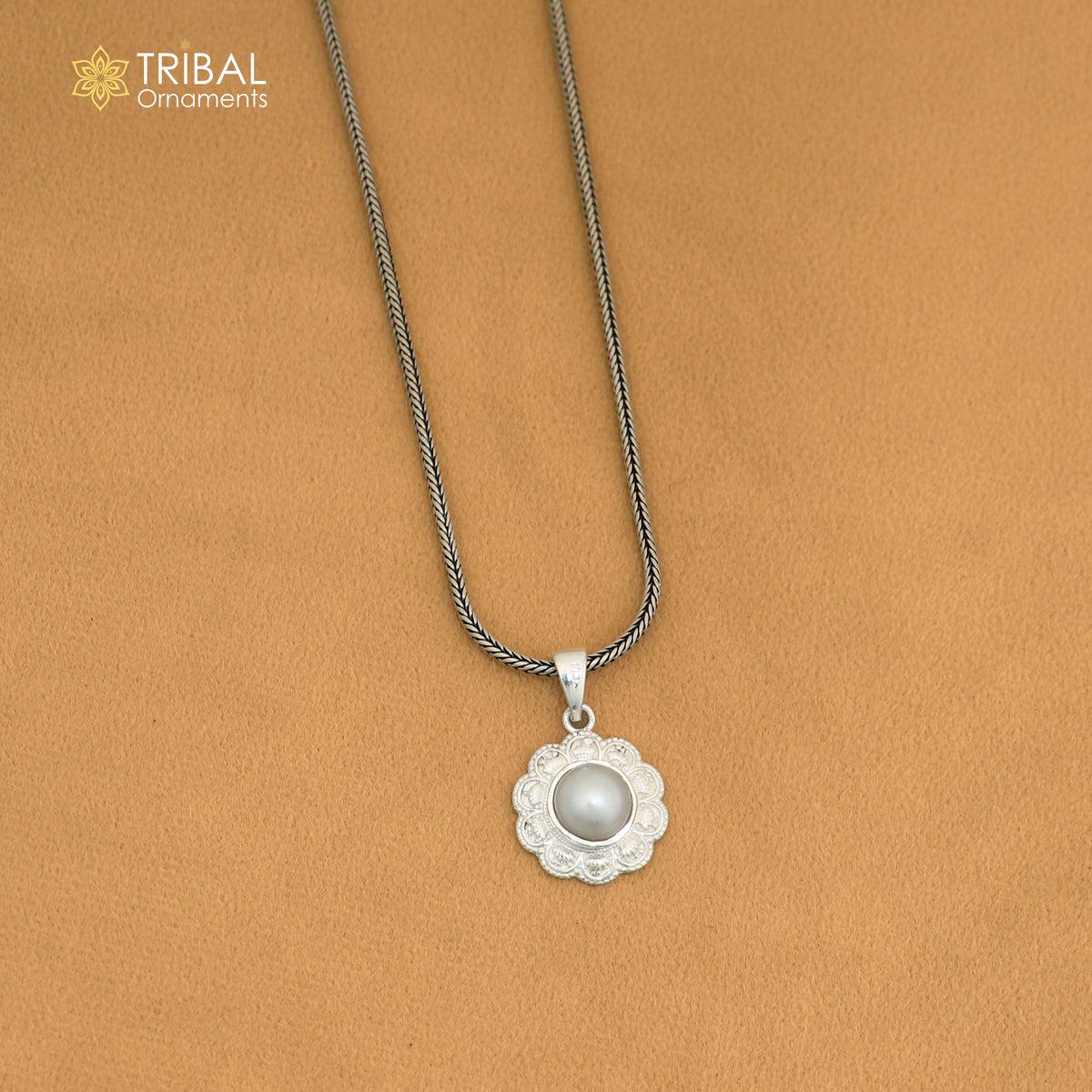 Sterling silver round floral pendant with pearl, unisex jewelry by TRIBAL ORNAMENTS, featuring intricate floral design and hanging pearl.