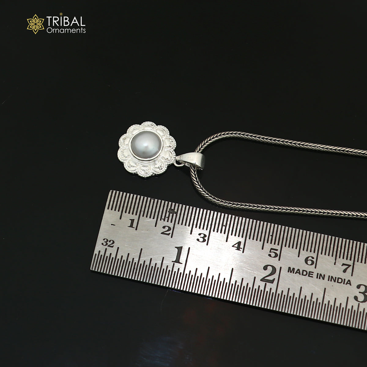 Sterling silver floral round pendant with pearl, unisex jewelry by TRIBAL ORNAMENTS, featuring intricate floral design and smooth pearl accent.