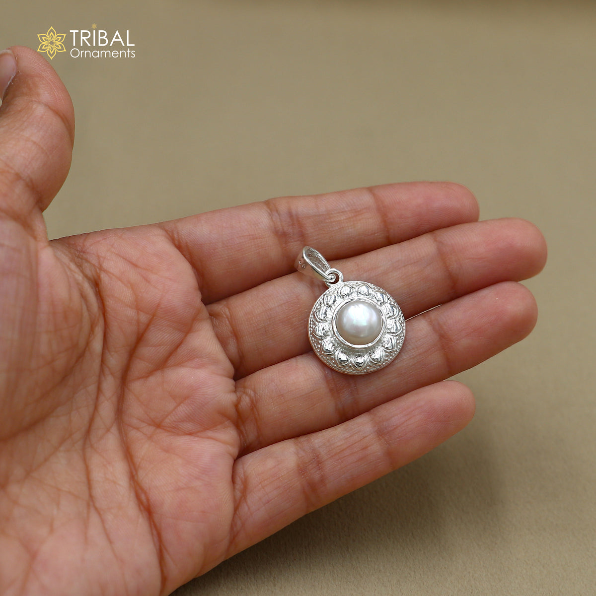 Sterling silver floral round pendant with pearl, unisex jewelry by TRIBAL ORNAMENTS featuring intricate floral design and a pearl accent.