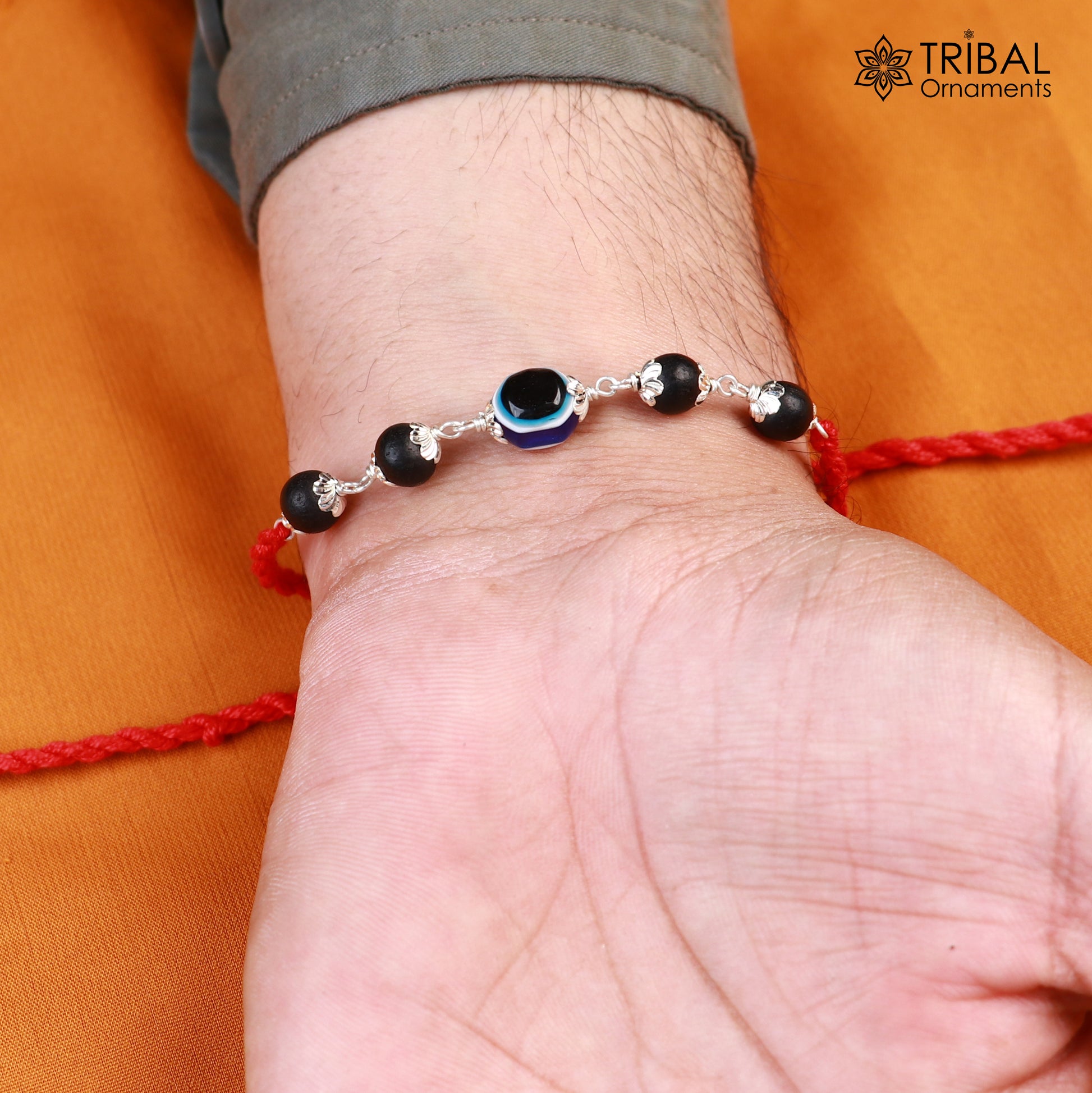 Sterling silver KARUNGALI and evil eye beads red thread rakhi bracelet with intricate tribal design, ideal for festival gifting.