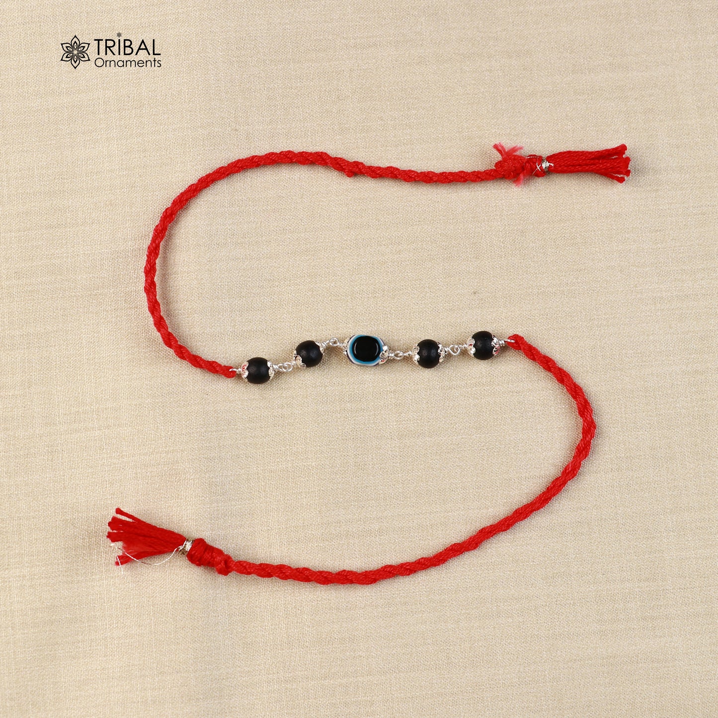 925 sterling silver KARUNGALI and evil eye beads red thread rakhi bracelet with intricate design from Tribal Ornaments.