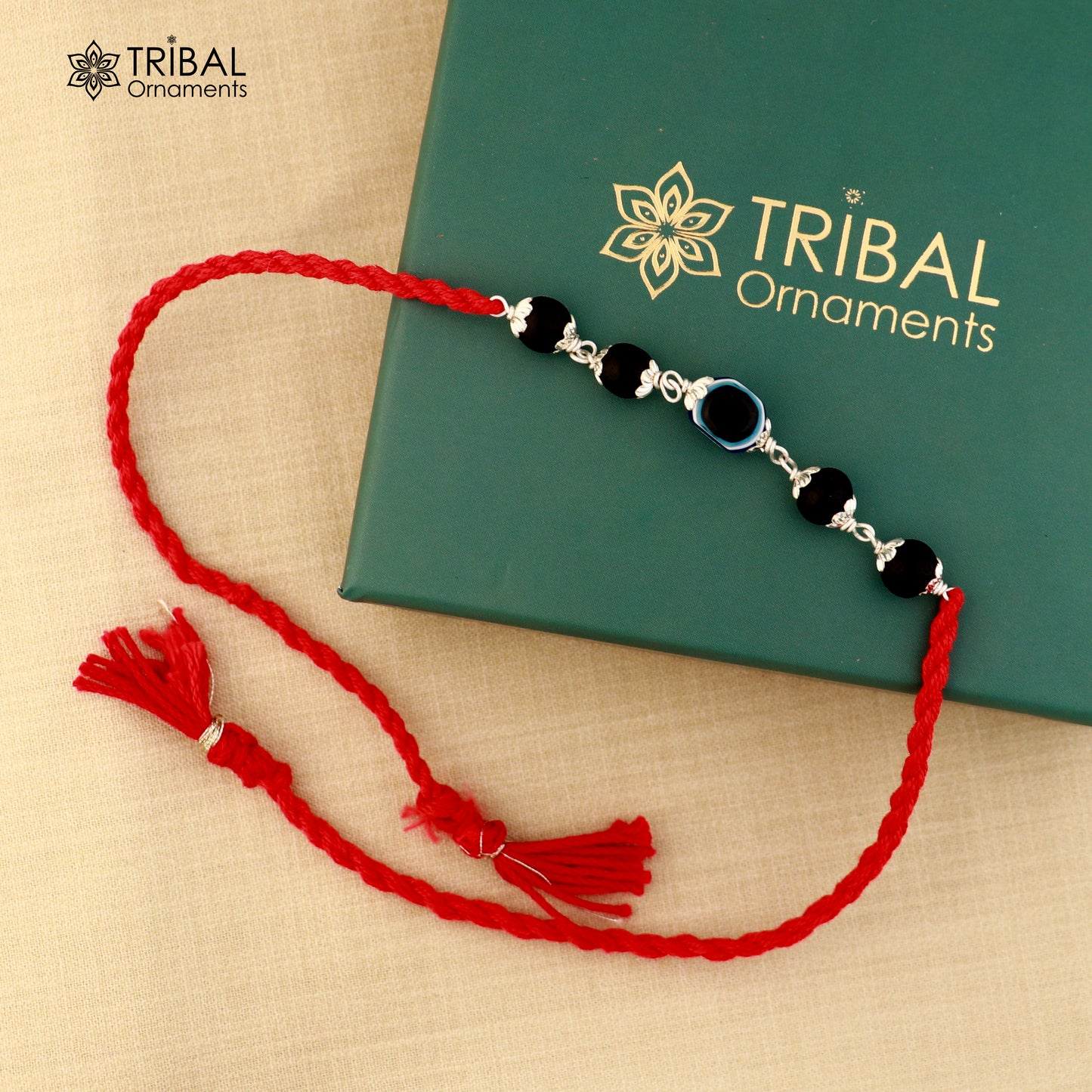 925 silver KARUNGALI and evil eye beads red thread rakhi bracelet with tribal design, handcrafted by TRIBAL ORNAMENTS.