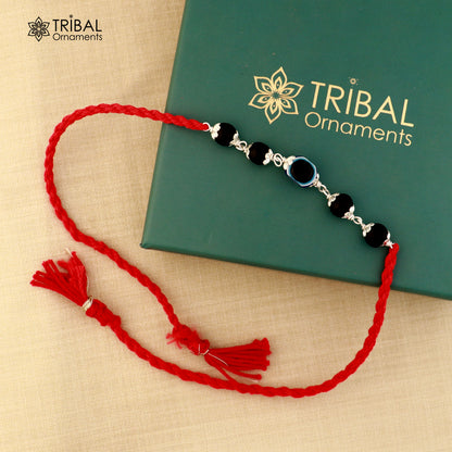 925 silver KARUNGALI and evil eye beads red thread rakhi bracelet with tribal design, handcrafted by TRIBAL ORNAMENTS.