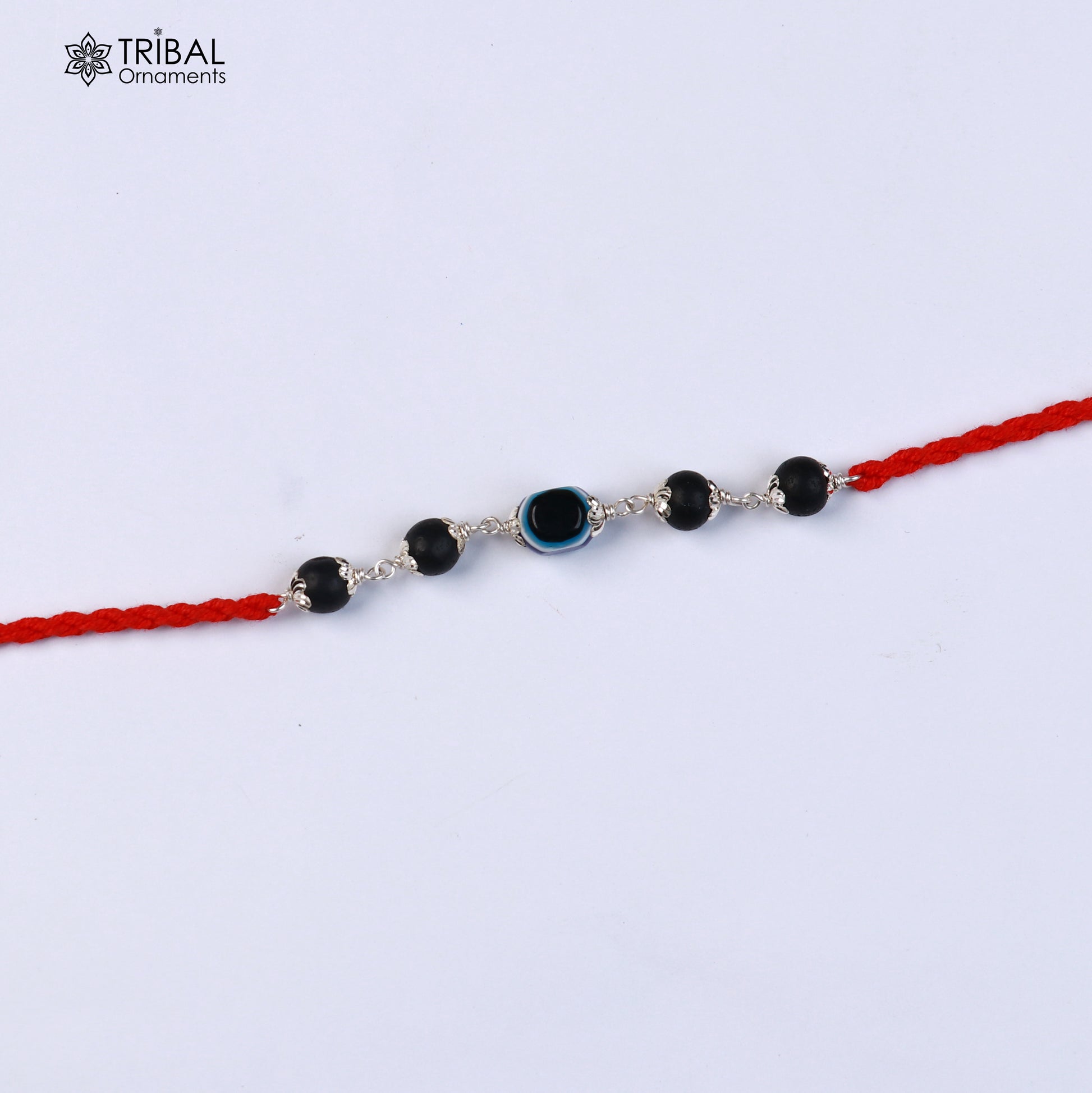 Sterling silver KARUNGALI and evil eye beads red thread rakhi bracelet with intricate details from TRIBAL ORNAMENTS.