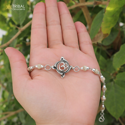Sterling silver OM design Rudraksha and Tulsi beads bracelet rakhi with intricate detailing, crafted by TRIBAL ORNAMENTS.