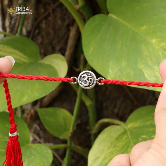 Sterling silver Hindu mantra "Aum" OM design thread rakhi bracelet with intricate details, crafted by TRIBAL ORNAMENTS.