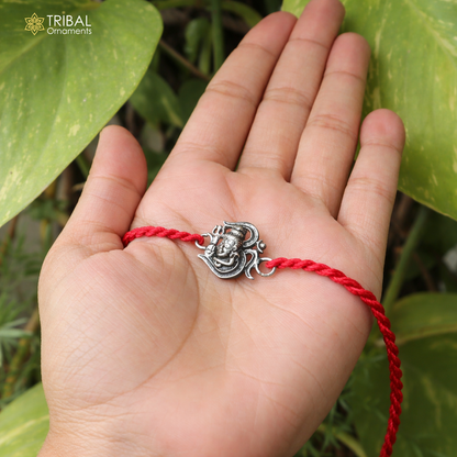 Sterling silver Lord Shiva with Aum design thread rakhi bracelet by TRIBAL ORNAMENTS featuring intricate religious motifs.