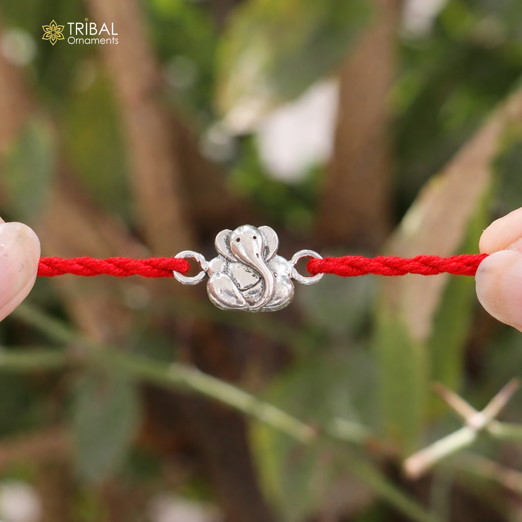 Sterling silver Lord Ganesha thread rakhi bracelet with intricate design by TRIBAL ORNAMENTS, featuring traditional Indian craftsmanship.