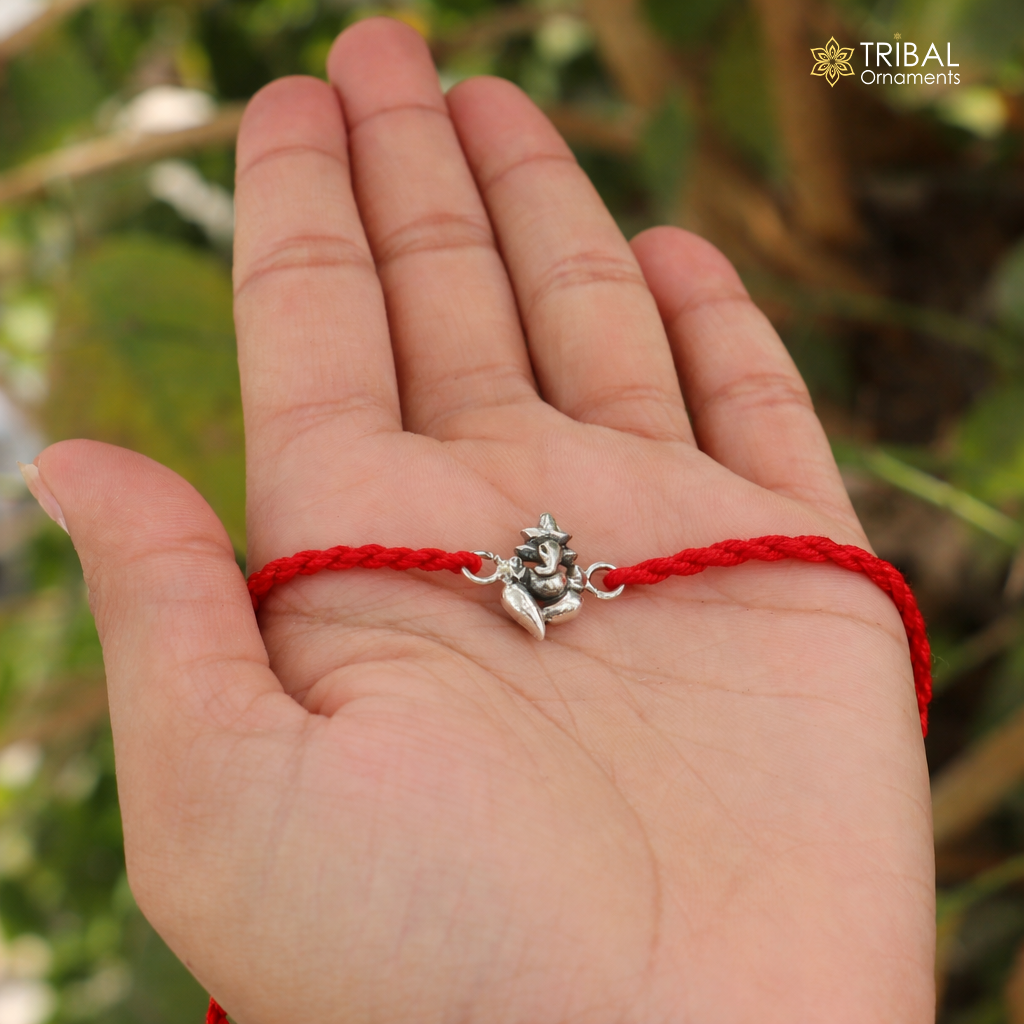 925 Sterling silver Lord Ganesha thread rakhi bracelet with intricate design from TRIBAL ORNAMENTS, featuring detailed craftsmanship.