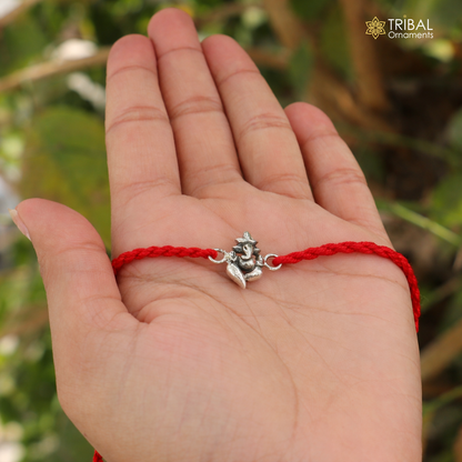 925 Sterling silver Lord Ganesha thread rakhi bracelet with intricate design from TRIBAL ORNAMENTS, featuring detailed craftsmanship.