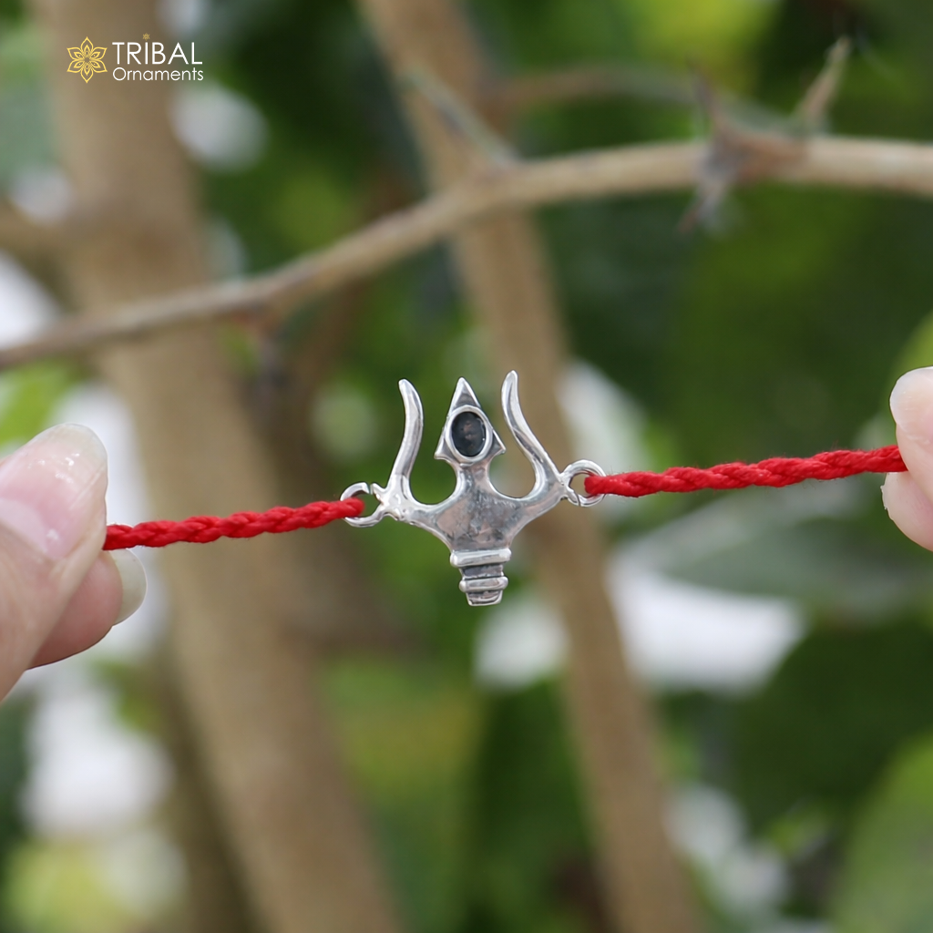 Sterling silver Trishul thread rakhi bracelet with Trident design from TRIBAL ORNAMENTS, showcasing intricate craftsmanship.