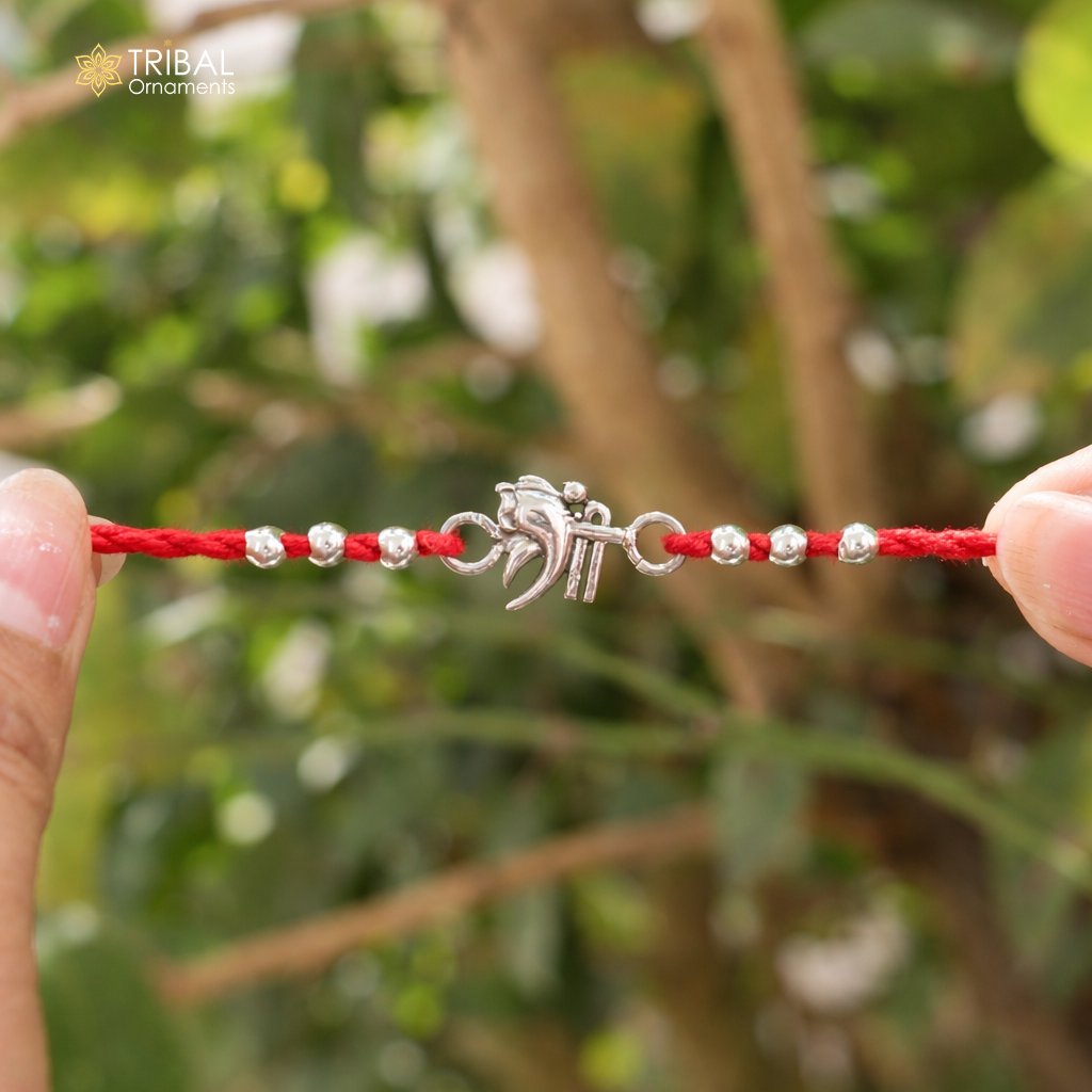 Handmade 925 sterling silver Shree Ganesha design bracelet thread Rakhi by TRIBAL ORNAMENTS, featuring intricate Ganesha motifs.