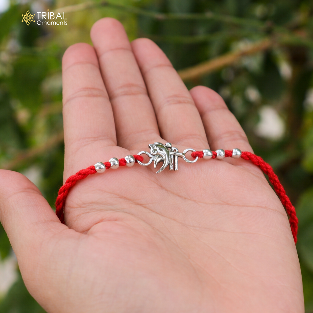Sterling silver handmade Shree Ganesha design bracelet thread rakhi by TRIBAL ORNAMENTS, featuring intricate Ganesha motifs.