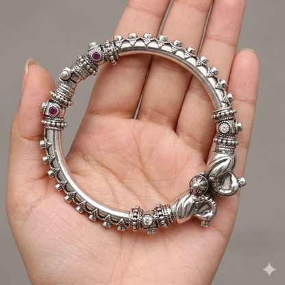 Sterling silver peacock design bangle bracelet with cubic zircon stones by TRIBAL ORNAMENTS, featuring screw closure and intricate details