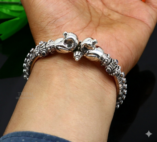 Sterling silver peacock design bangle bracelet with cubic zircon stones, featuring screw closure, by TRIBAL ORNAMENTS.
