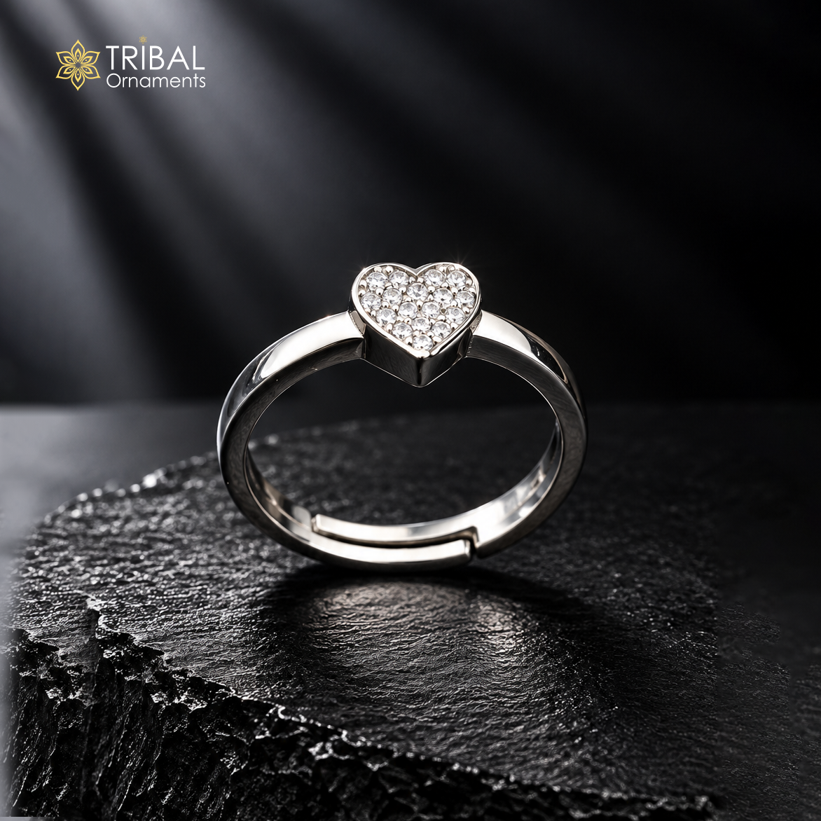 Sterling silver heart-shaped ring with cubic zirconia stones by TRIBAL ORNAMENTS, featuring a detailed design and polished finish.