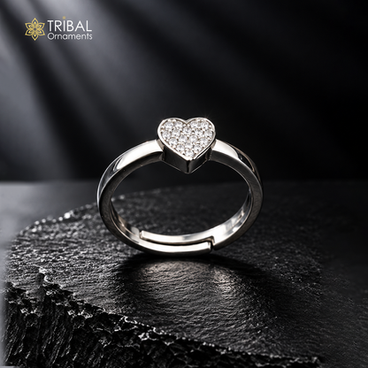 Sterling silver heart-shaped ring with cubic zirconia stones by TRIBAL ORNAMENTS, featuring a detailed design and polished finish.