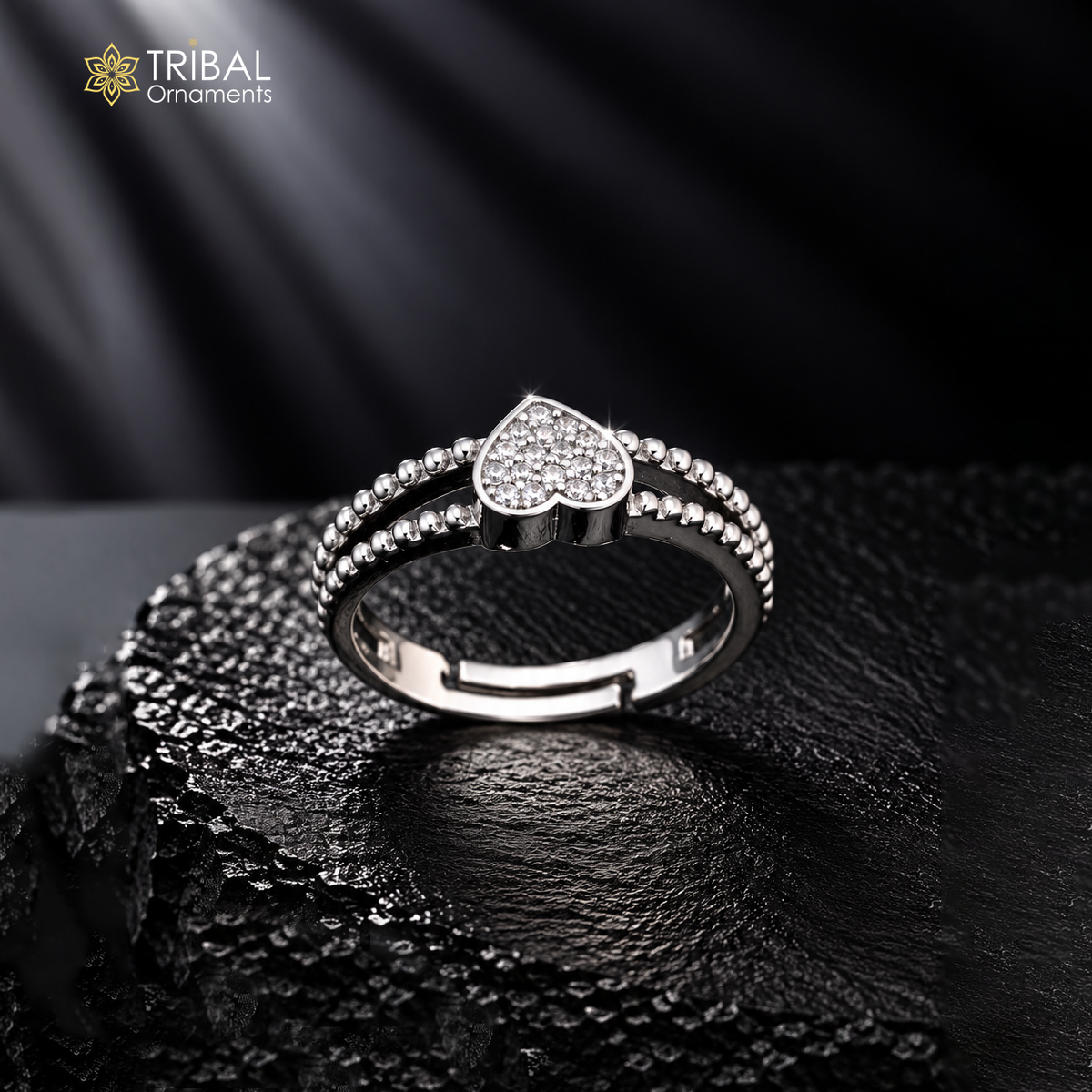 Sterling silver heart design CZ stone ring by TRIBAL ORNAMENTS featuring a polished band and sparkling gemstone accents.