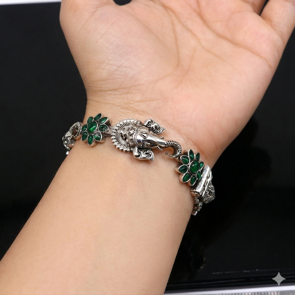 Sterling silver Ganesha design bangle bracelet with floral green stone, traditional ethnic jewelry by TRIBAL ORNAMENTS.