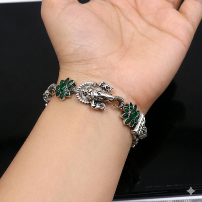 Sterling silver Ganesha design bangle bracelet with floral green stone, traditional ethnic jewelry by TRIBAL ORNAMENTS.