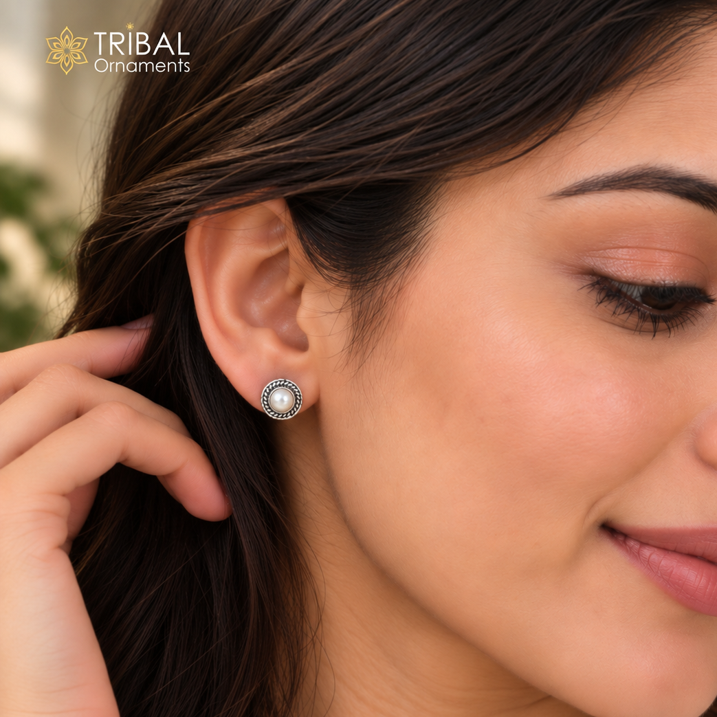 Sterling silver pearl stud earring with a smooth, round pearl stone from TRIBAL ORNAMENTS, showcasing elegant jewelry design.