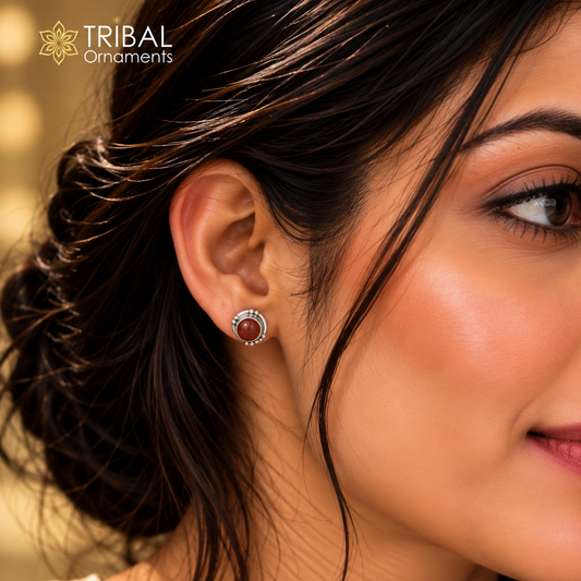 Unisex 925 sterling silver round brown stone stud earring by TRIBAL ORNAMENTS, featuring a polished silver setting and natural brown stone.