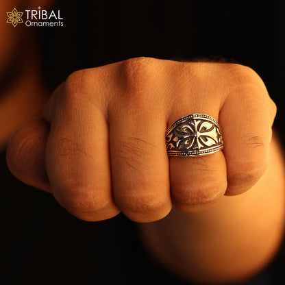 Sterling silver men's ring with intricate flower design by TRIBAL ORNAMENTS, showcasing detailed silver craftsmanship.