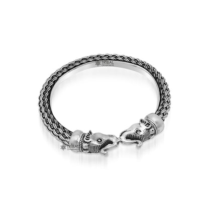 Sterling silver vintage elephant face bangle bracelet by TRIBAL ORNAMENTS, handmade Indian jewelry with intricate design.