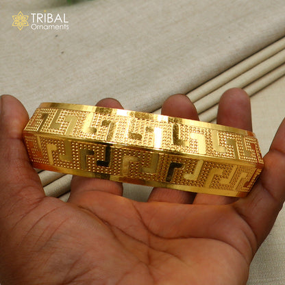 Stylish 999 pure silver gold-polished heavy bangle or kada with tribal design from TRIBAL ORNAMENTS.