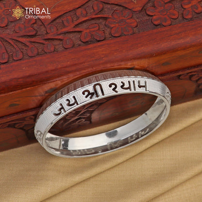 Stylish 999 pure silver Jai Shree Shyam Krishna mantra bangle from Tribal Ornaments, shiny and intricately designed.