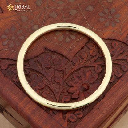 Unisex Ashtdhatu round tube style plain bangle bracelet by TRIBAL ORNAMENTS, showcasing a minimalist jewelry design.
