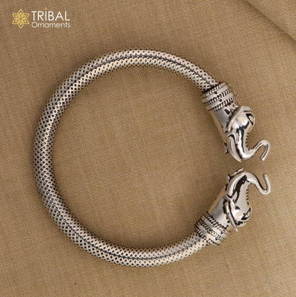Sterling silver elephant face bangle bracelet by TRIBAL ORNAMENTS, unisex silver kada with detailed elephant design.
