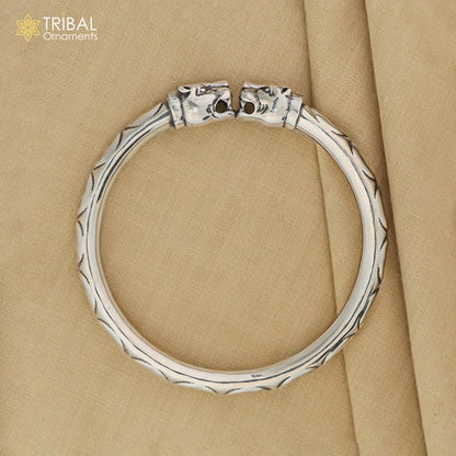 Sterling silver lion face design handcrafted bangle bracelet, unisex jewelry with detailed tribal ornament craftsmanship.