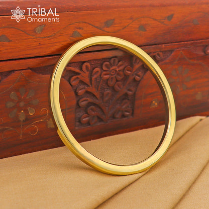 Shiny round flat Ashtdhatu kada bangle bracelet from TRIBAL ORNAMENTS, unisex plain jewelry, customizable and polished finish.