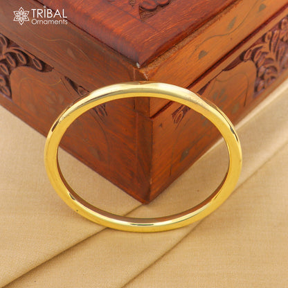 Shiny round flat Ashtdhatu Kada bangle by TRIBAL ORNAMENTS, customizable plain unisex jewelry with a polished finish.
