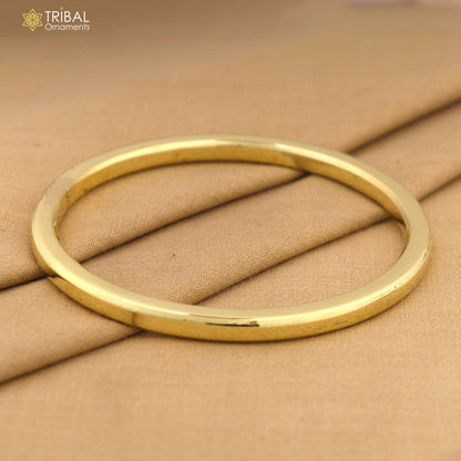Shiny unisex Ashtdhatu Kada bangle with round tube design, customized plain finish, tribal ornaments jewelry.