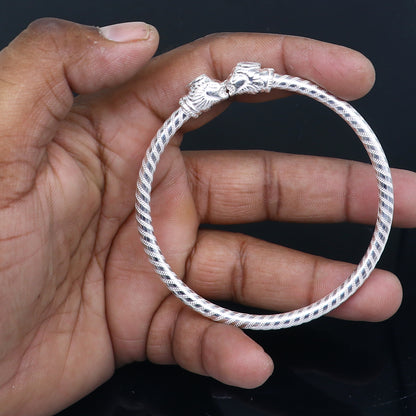 Sterling silver tribal bangle bracelet featuring a lion face design, handmade tribal jewelry by Tribal Ornaments.
