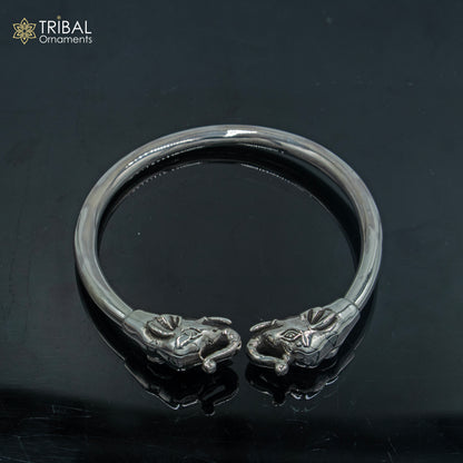 Sterling silver handmade elephant design bangle bracelet by TRIBAL ORNAMENTS, plain silver kada with detailed elephant motif.