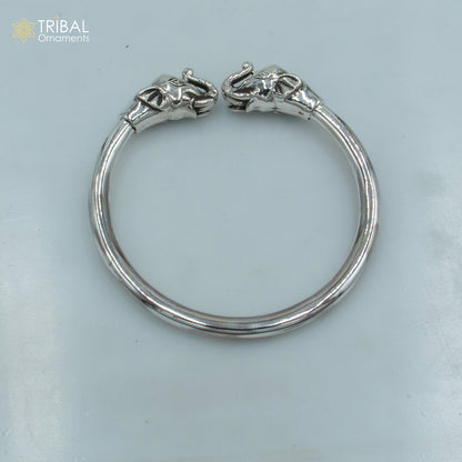 Sterling silver handmade elephant design plain bangle bracelet by TRIBAL ORNAMENTS, showcasing intricate elephant motifs on smooth silver band.