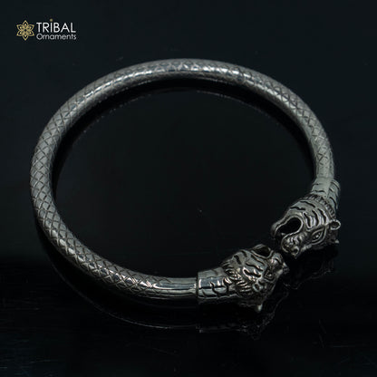 Handmade 925 sterling silver lion face design bangle bracelet by TRIBAL ORNAMENTS, showcasing intricate tribal craftsmanship.