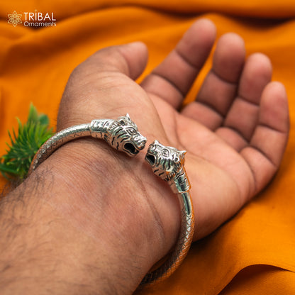 Sterling silver handmade lion face design bangle bracelet by TRIBAL ORNAMENTS, featuring detailed craftsmanship and traditional style.