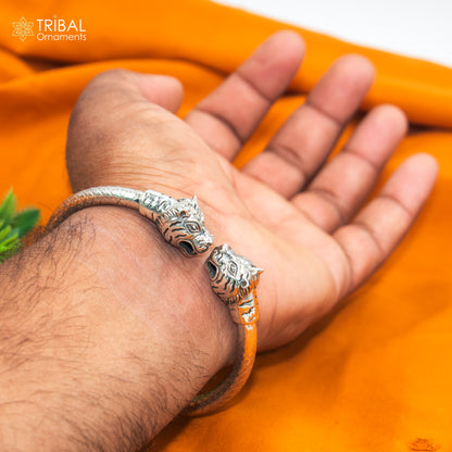 Sterling silver handmade lion face bangle bracelet by Tribal Ornaments, 2.5-inch tribal jewelry design with intricate detailing.