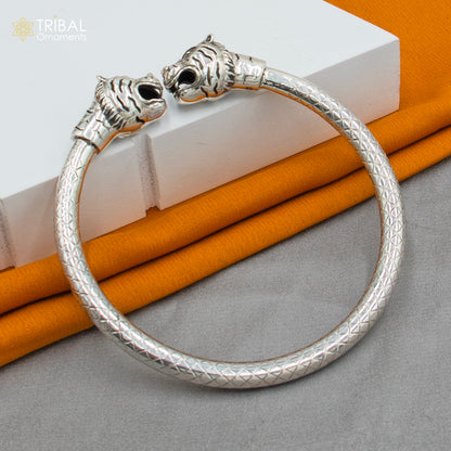 Sterling silver handmade lion face bangle bracelet from TRIBAL ORNAMENTS, featuring detailed tribal-inspired design and adjustable fit