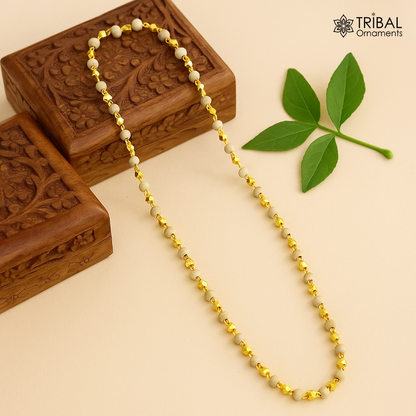 Sterling silver handmade wooden basil rosary beads on a silver chain over a gold-polished necklace, tribal-style tulsi mala jewelry.
