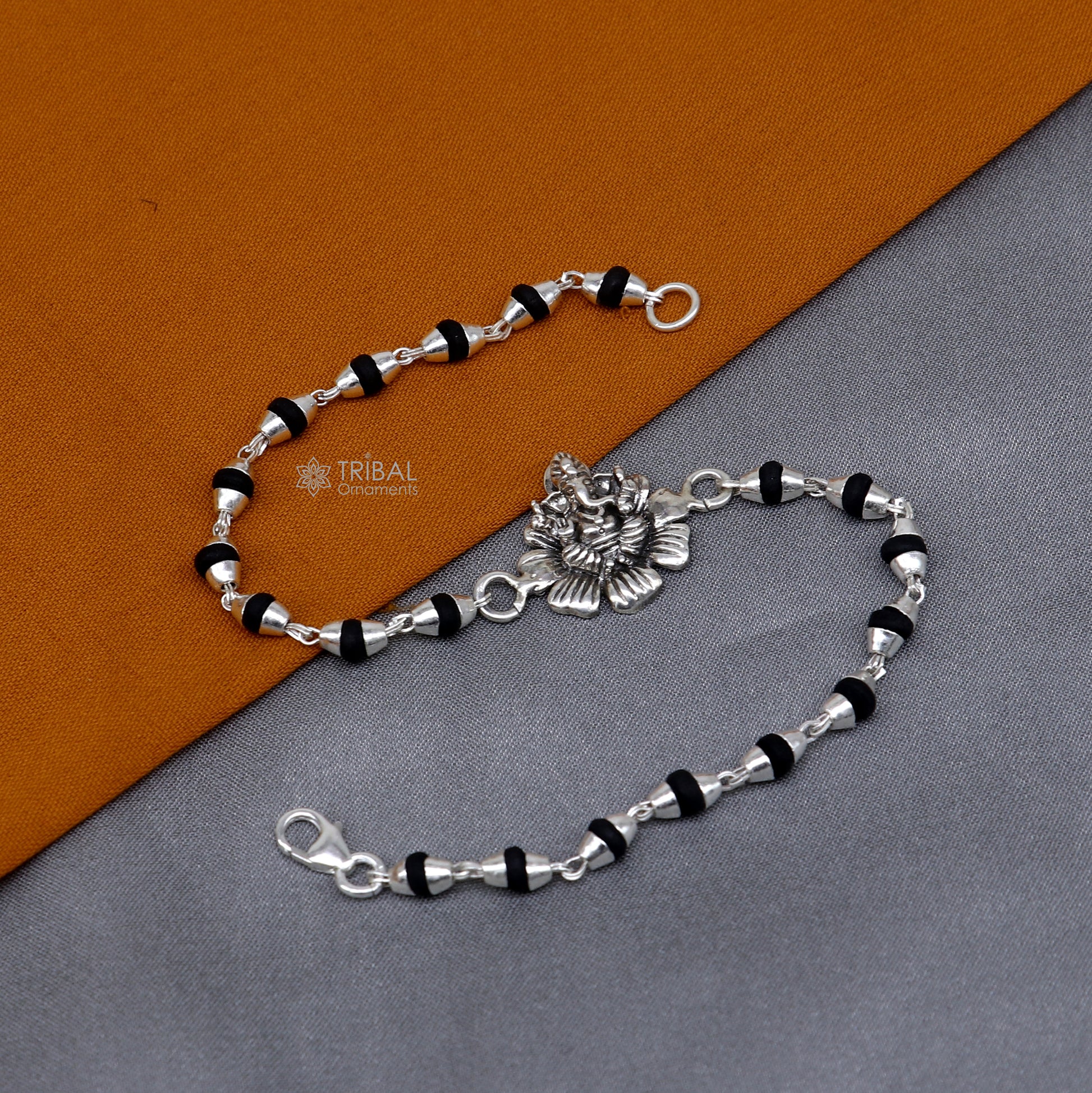 925 sterling silver Lord Ganesha bracelet with black Tulsi beads and flower design, handmade jewelry by TRIBAL ORNAMENTS.