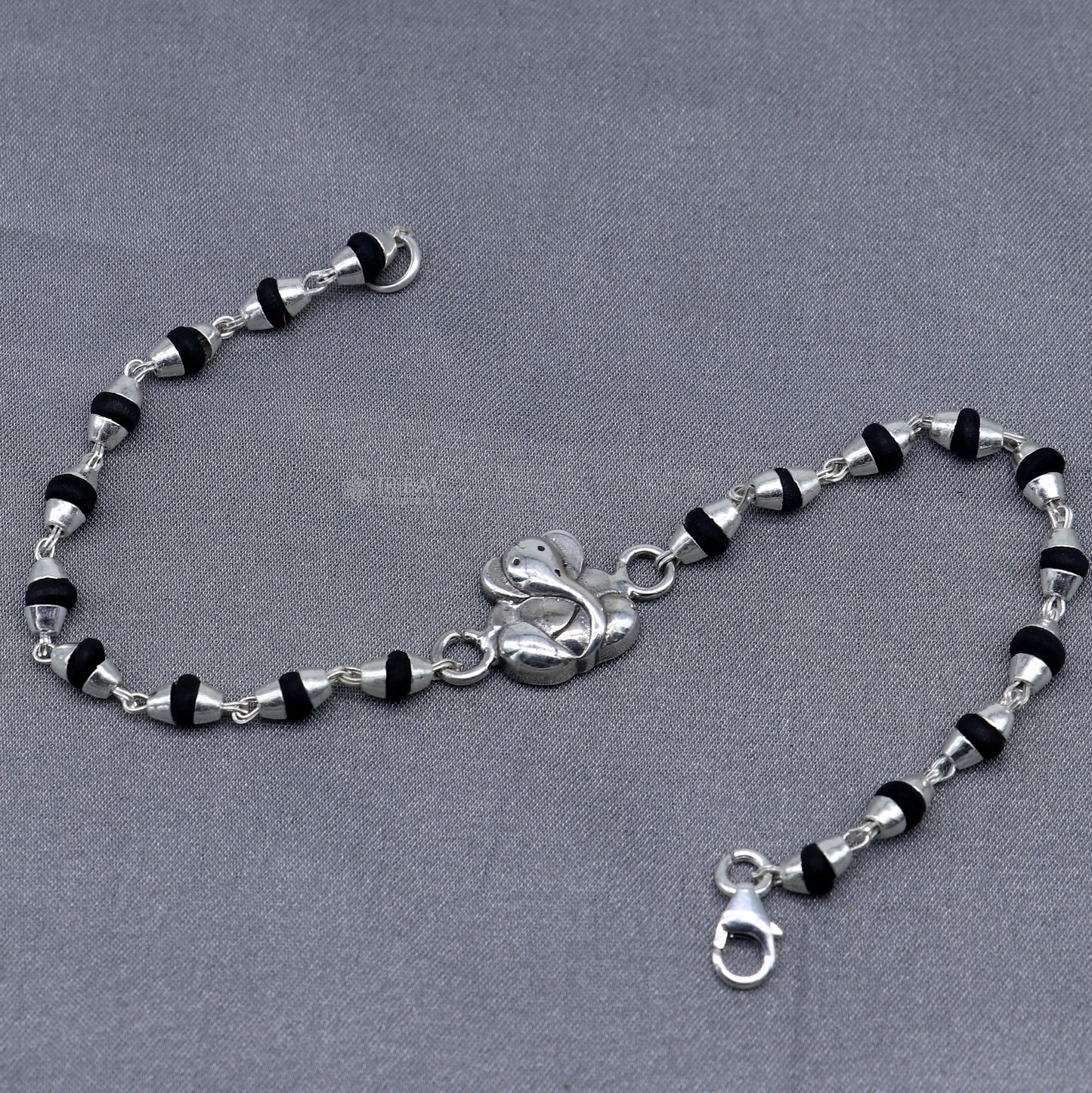 Sterling silver Lord Ganesha bracelet with black Tulsi beaded design and handmade Ganesha motif, from Tribal Ornaments.