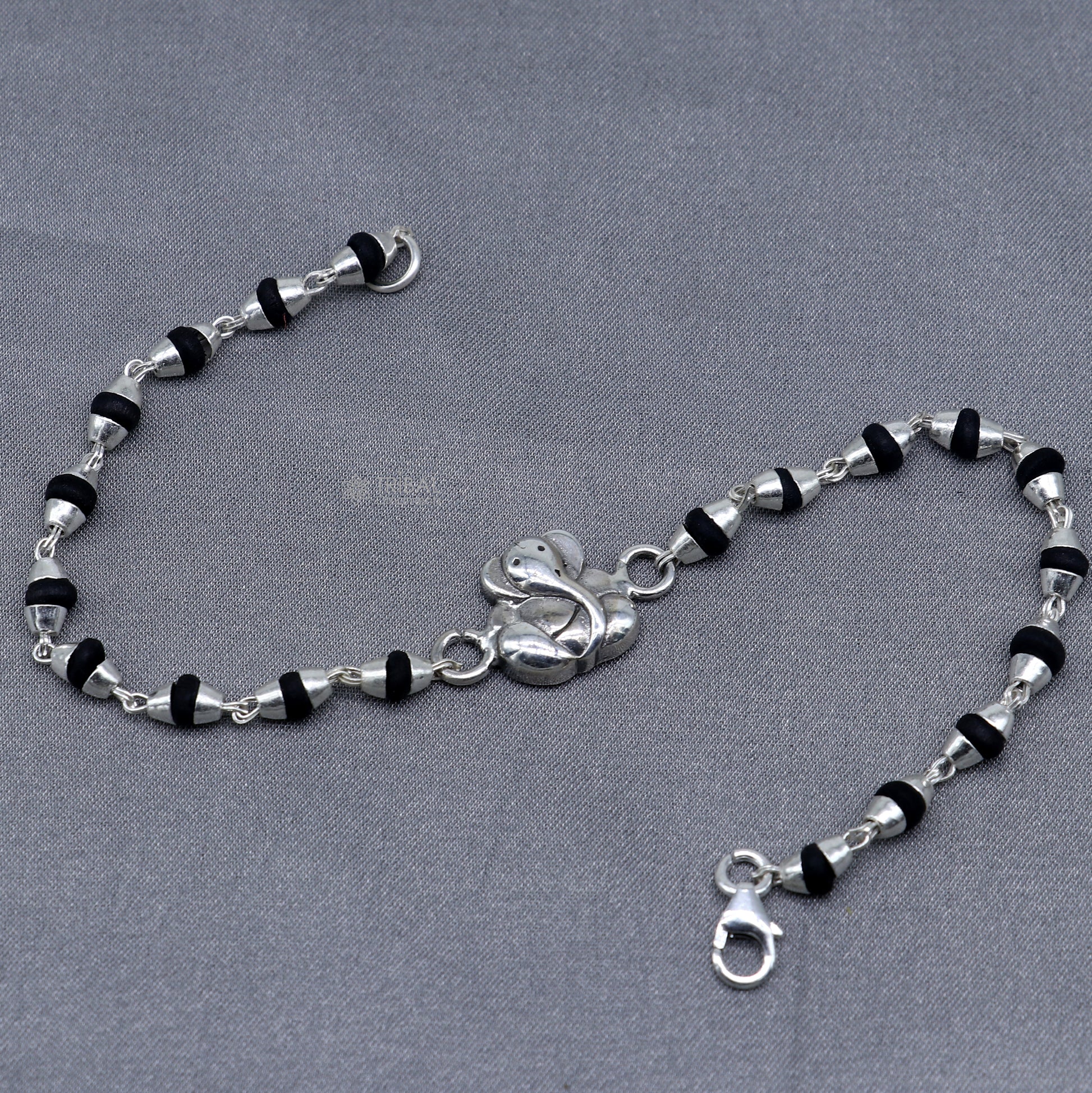 Sterling silver Lord Ganesha bracelet with black Tulsi beaded design and handmade Ganesha motif, from Tribal Ornaments.