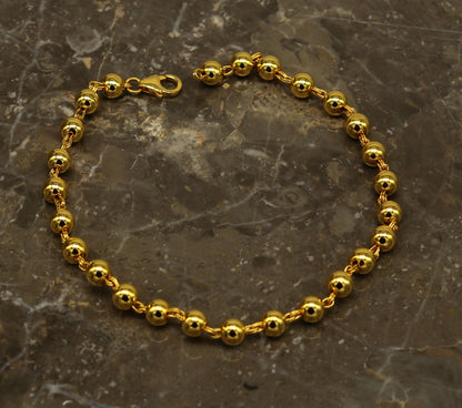 Sterling silver handmade beaded bracelet with polished gold accents, stylish unisex jewelry from Tribal Ornaments.