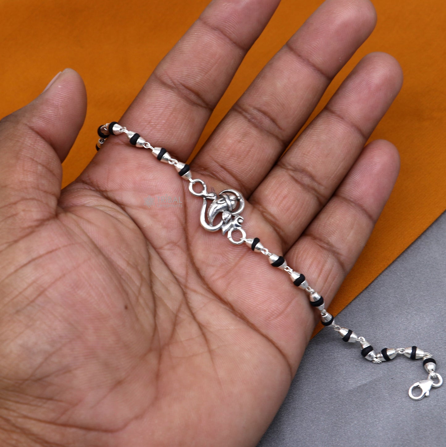 Sterling silver Lord Ganesha bracelet with black Tulsi beads and basil rosary beads, handmade by Tribal Ornaments.